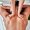 A close-up shot of a person's back being massaged with deep pressure to target muscle knots.